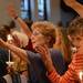 Sara King, of Ann Arbor, raises her arm and sings during a prayer vigil in support of Camp Take Notice at St. Mary Student Parish on Thursday night.  Melanie Maxwell I AnnArbor.com